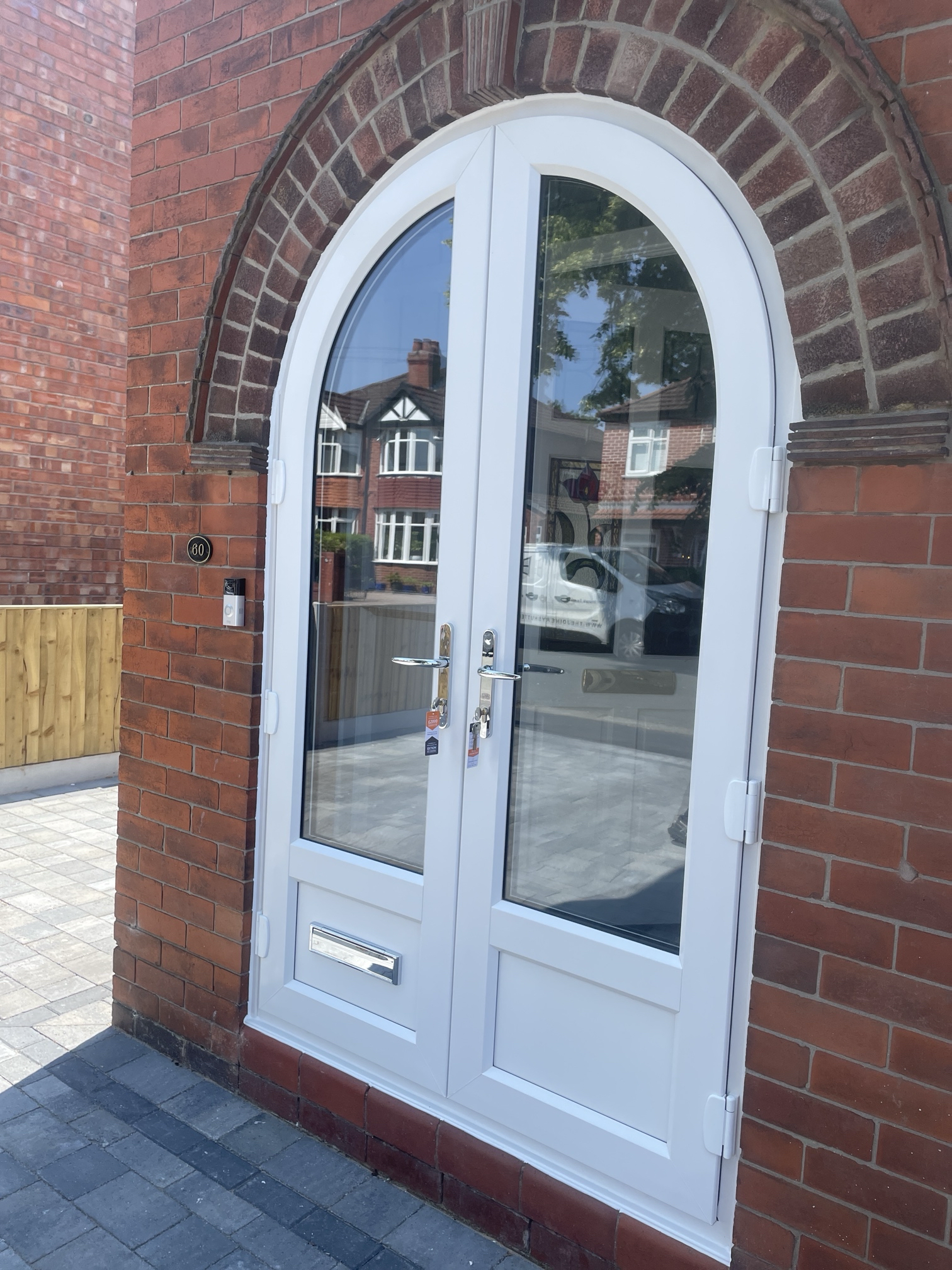 Arched white PVC French doors with lower mid-rail