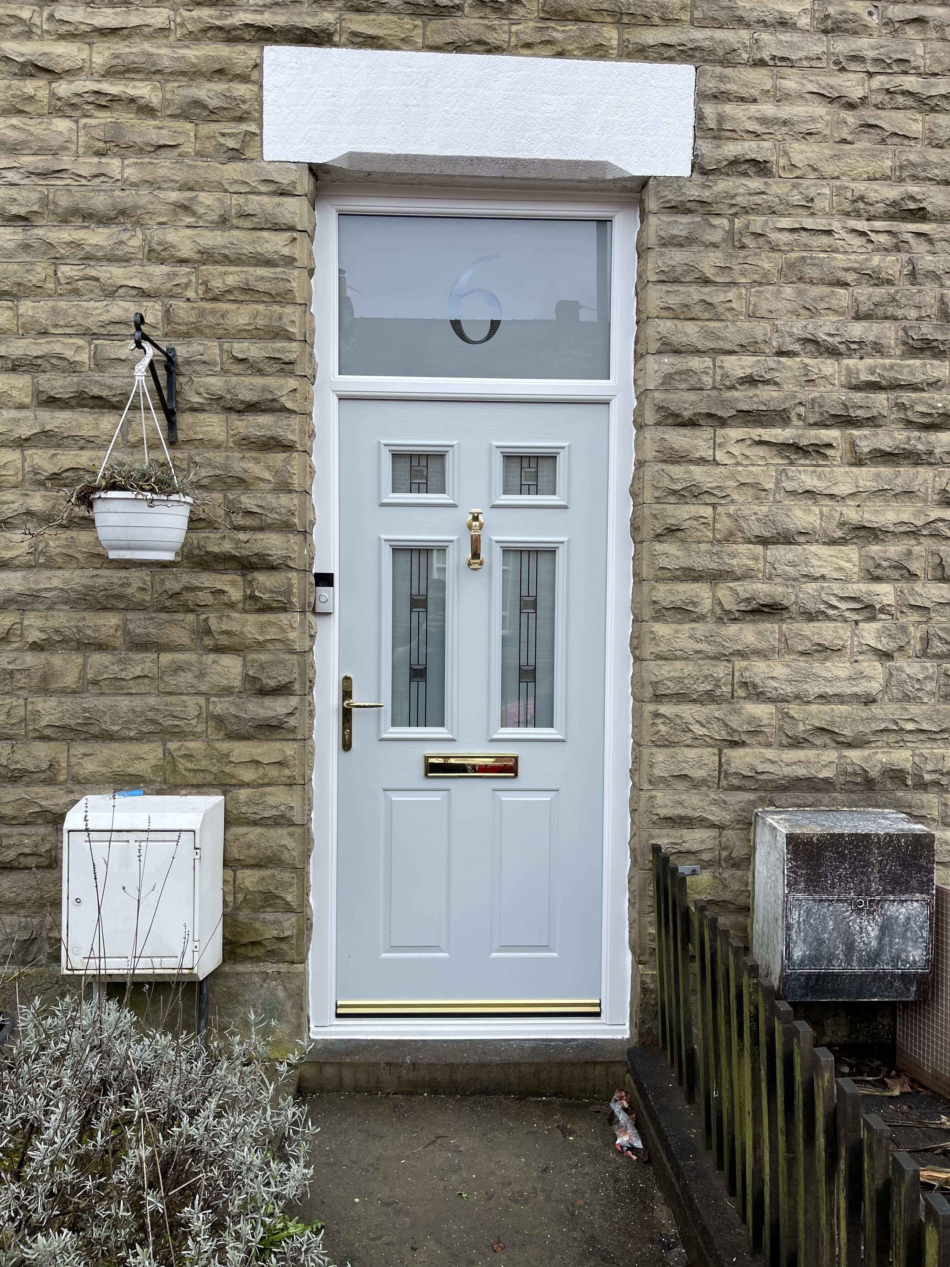 Ral 7032 light grey traditional front composite door with white door frame and satin glass with clear number above in authentic font