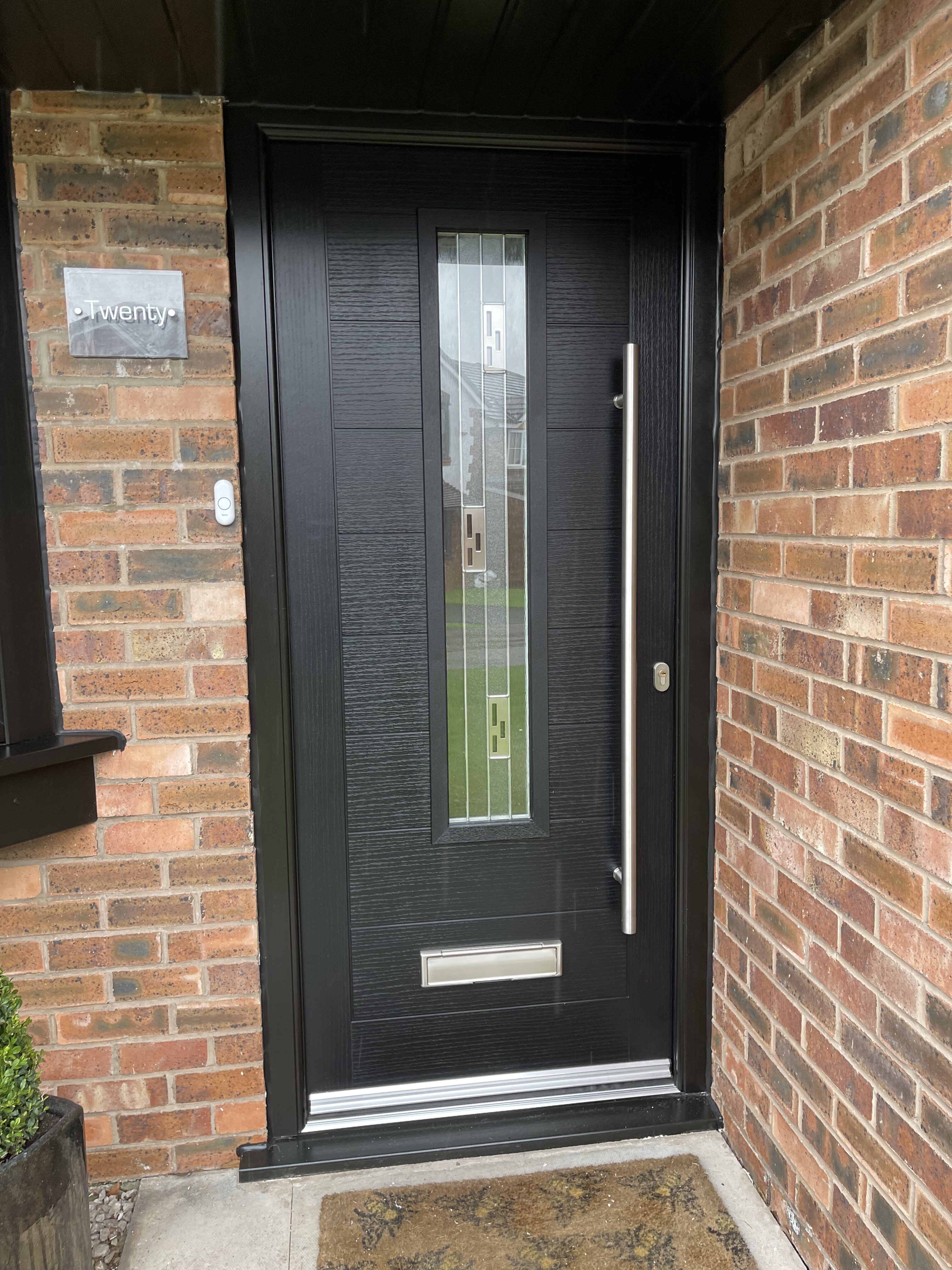 Black front modern composite door with 1200mm long bar handle