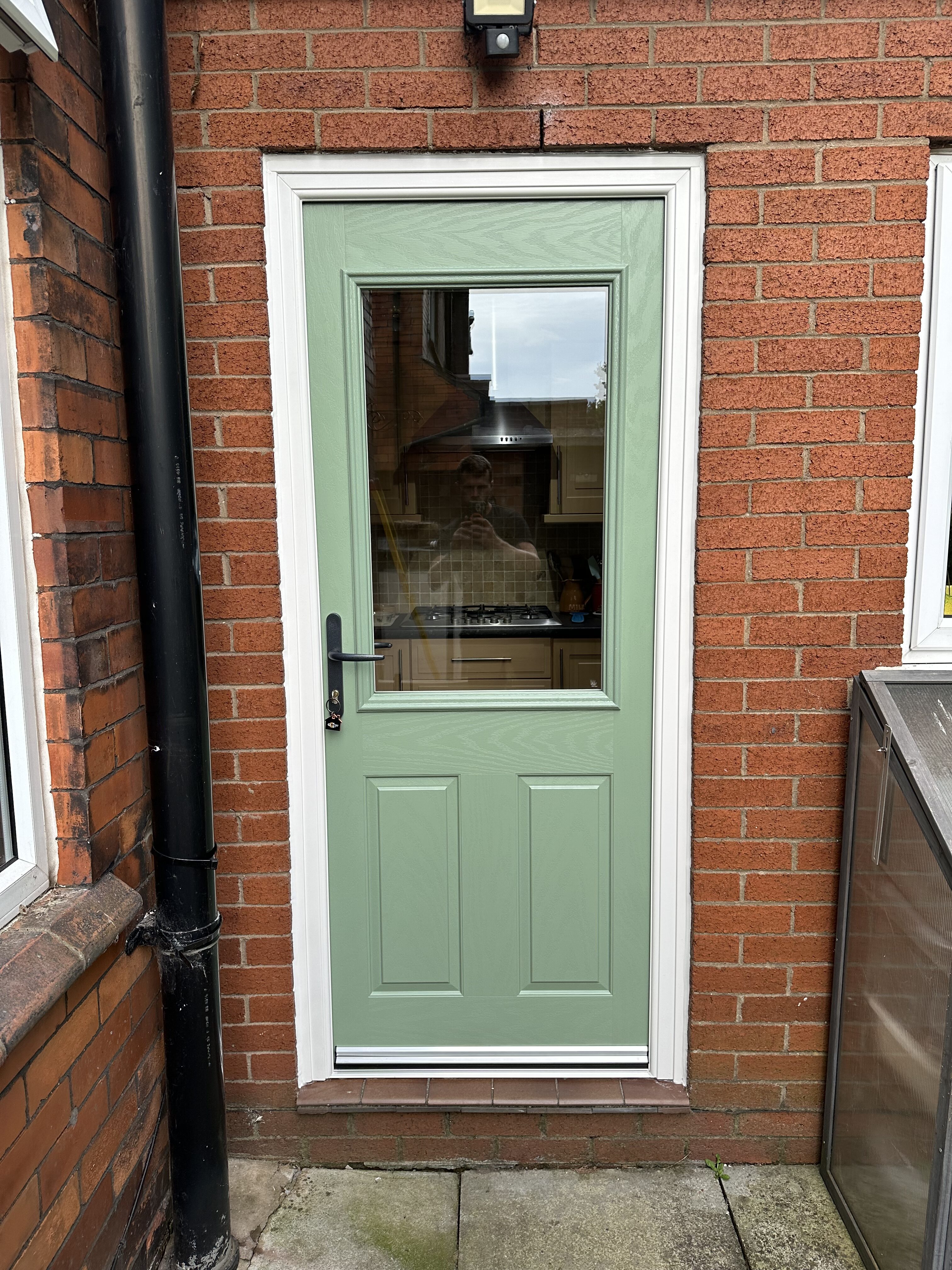 Chartwell green door slab with white frame composite back door with clear glass and antique black door handle