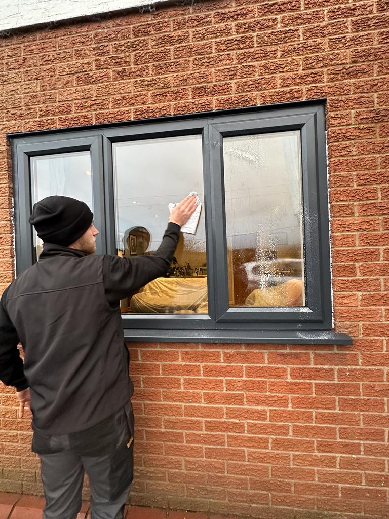 Black windows being wiped down